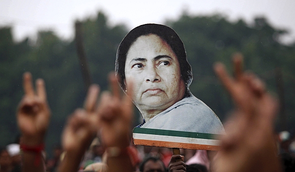 Supporters hold a cut-out of Mamata Banerjee during a rally in Kolkata