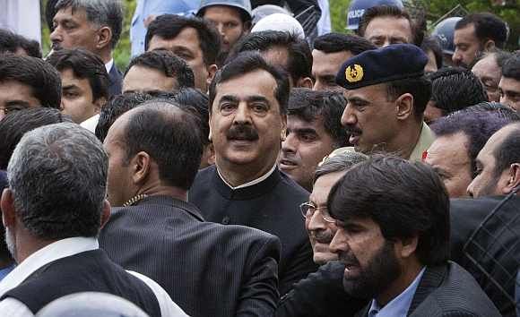 Pakistan's Prime Minister Yousuf Raza Gilani waves after arriving at the supreme court in Islamabad on Thursday