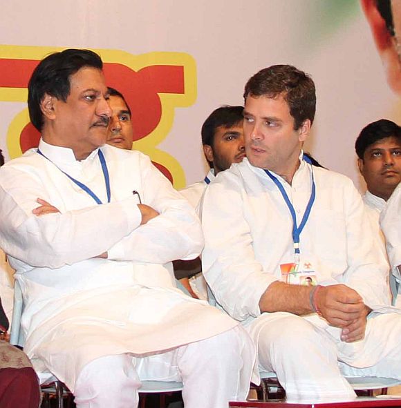 Rahul Gandhi speaks with CM Chavan during a conference at Ville Parle, Mumbai on Friday