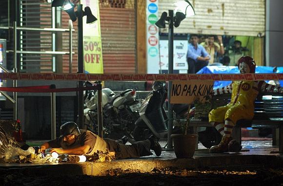 A policeman inspects the site of an explosion near McDonalds restaurant in Pune