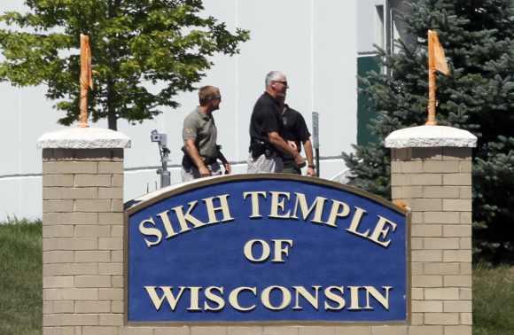 Officials gather near the Sikh Temple in Oak Creek in Wisconsin August 5 following a mass shooting inside and outside the gurudwara