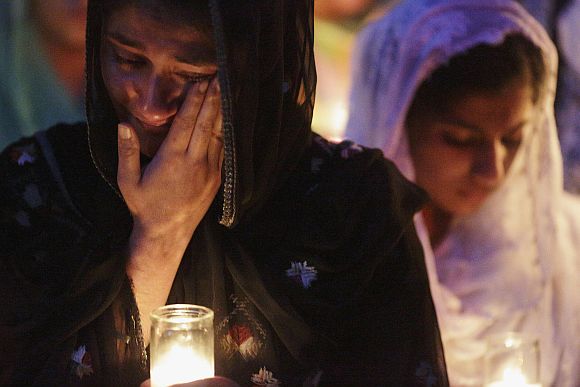 Mourners cry during a candlelight vigil at the Sikh temple in Brookfield, Wisconsin