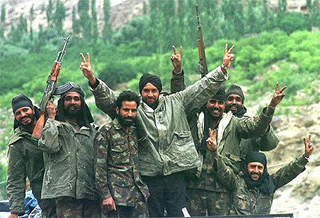 Indian soldiers show the victory signs in Drass after India captured Tiger Hill in northern Kashmir on July 4, 1999