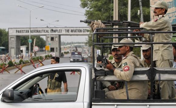 Paramilitary soldiers guard near the main entrance of the Minhas in the town of Kamra in Punjab province