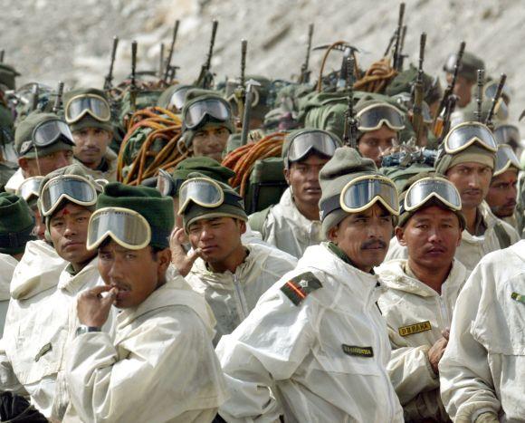 Indian army soldiers muster at their base camp after returning from training at Siachen Glacier