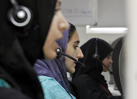 Employees talk to customers at a call centre. Image used for representational purposes only