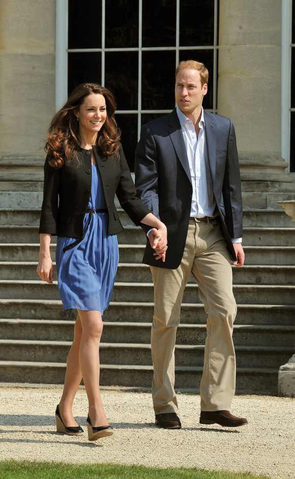 Prince William, Duke of Cambridge and Catherine, Duchess of Cambridge walk hand in hand from Buckingham Palace