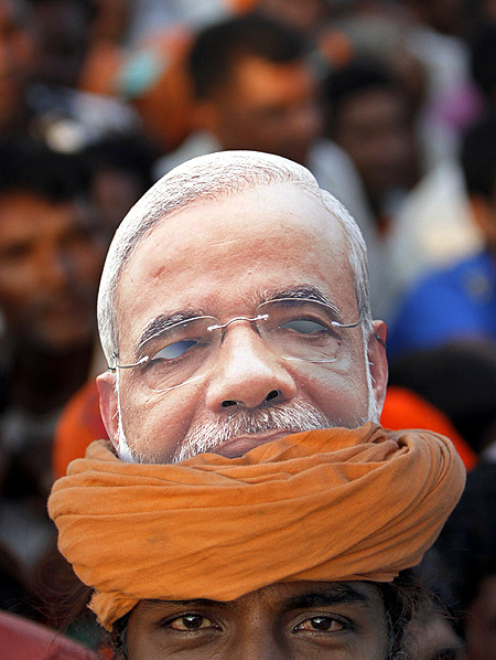 A supporter with a picture of Narendra Modi on his turban at a rally in Pavagadh