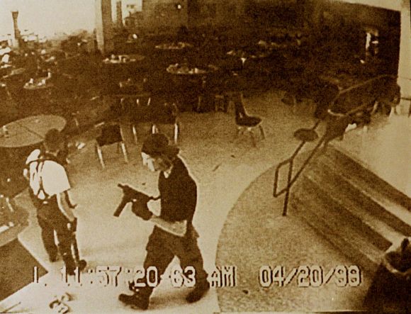 Shooters Dylan Klebold (R) and Eric Harris are shown in the Columbine High School cafeteria on April 20, 1999, in a still image from a security camera