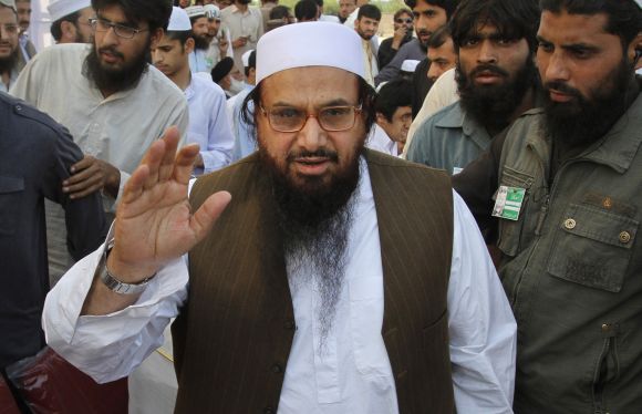 Hafiz Saeed gestures as he arrives to attend a rally in Peshawar