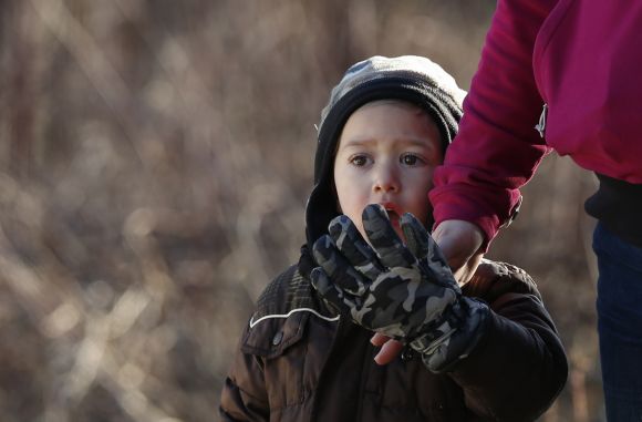 A child reacts to police and fireman staged nearby Sandy Hook Elementary School