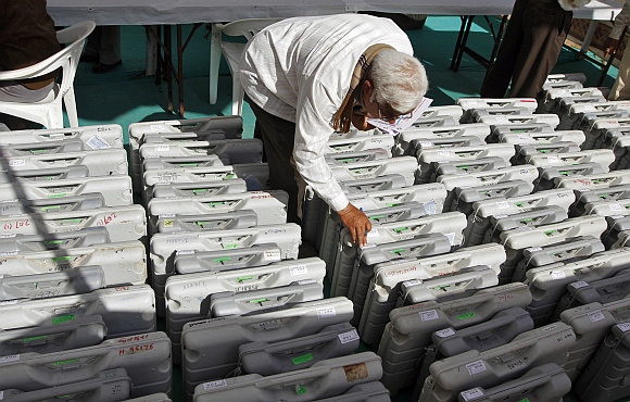 A polling official checks a tag on an EVM