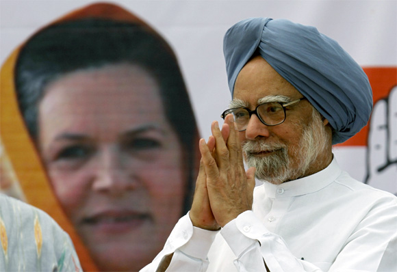 India's Prime Minister Manmohan Singh gestures to supporters of the Congress Party during a rally in Ahmedabad