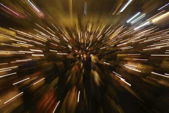 Demonstrators hold candles during a candlelight vigil for a gang rape victim who was assaulted in New Delhi