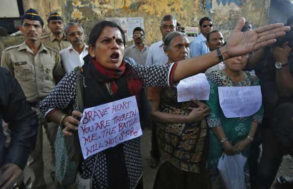 A demonstrator shouts at police officers as she takes part in a demonstration to mourn the death of a rape victim who was assaulted in New Delhi, in Mumbai