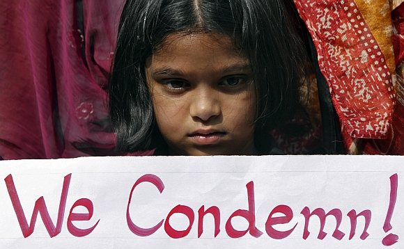 A girl holds a placard as she takes part in a protest rally in Hyderabad