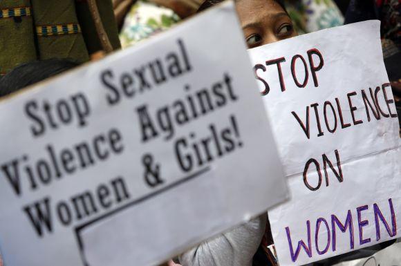 Demonstrators hold placards during a protest in New Delhi on Saturday