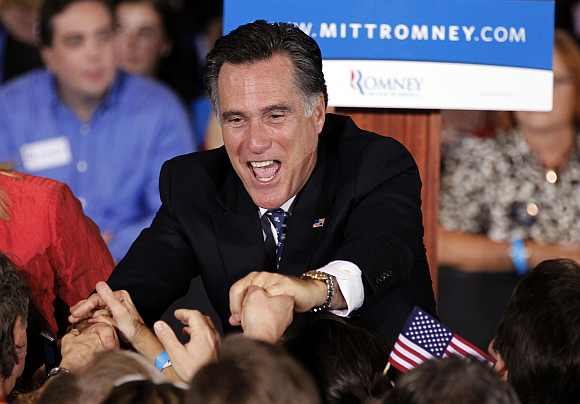 US Republican presidential candidate and former Massachusetts Governor Mitt Romney shakes hands with supporters after speaking at his Florida primary night rally in Tampa, Florida