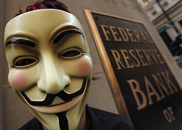 A protestor demonstrates in support of the New York Occupy Wall Street protests in front of the Federal Reserve Bank of Chicago in the city's financial district