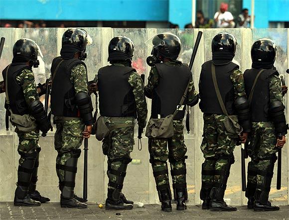 Maldivian riot police officers stand guard as they block the supporters of ousted Maldivian president Mohamed Nasheed during a clash in Male