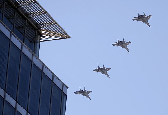 Chinese Air Force fighter jets fly over a building near Beijing's Tiananmen during a rehearsal for the National Day parade.