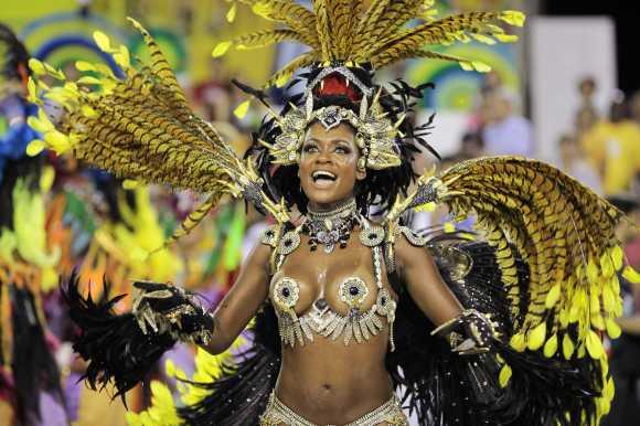 Revellers from the Beija-Flor samba school parade on the first night of the annual Carnival parade in Rio de Janeiro's Sambadrome