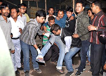 An injured man being taken to hospital