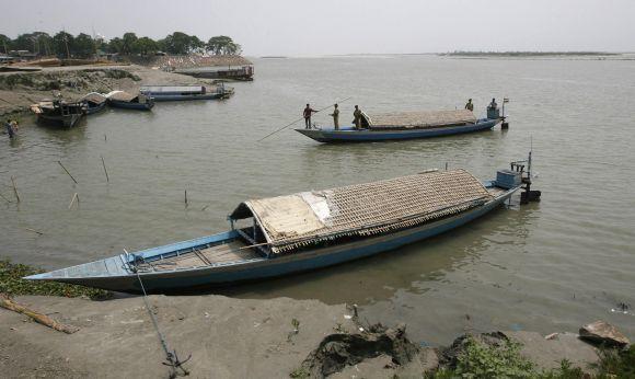 BSF soldiers patrol on a boat in the waters of river   Brahmaputra in Assam