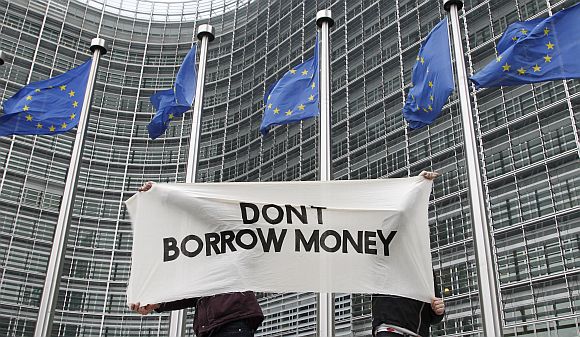 Students display a banner outside the EU Commission headquarters ahead of an European Union summit in Brussels