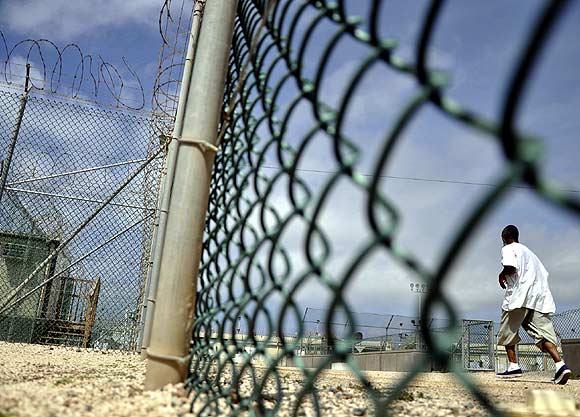 A Guantanamo detainee runs inside an exercise area at the detention facility