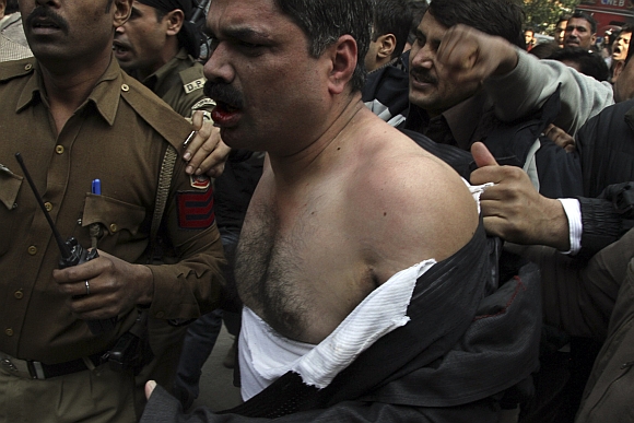 Man who threw ink on Ramdev taken to a police station in New Delhi