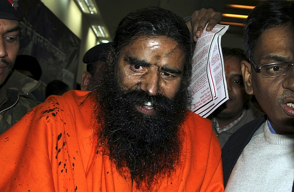 Yoga guru Baba Ramdev reacts after a man attempted to throw ink on his face