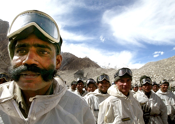 Indian army soldiers muster at their base camp after returning from training at Siachen Glacier
