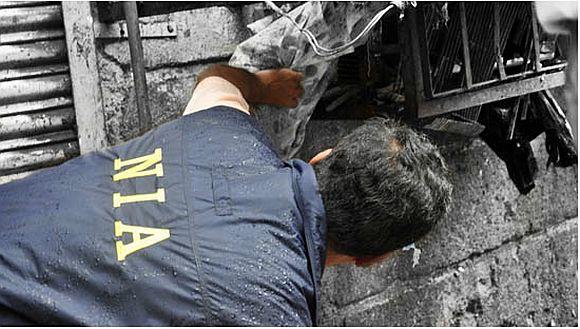 A NIA officer investigating the site of a bomb blast in Mumbai