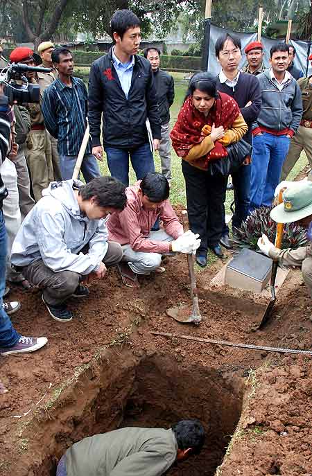 A team of Indian and Japanese officials oversee the exhumation