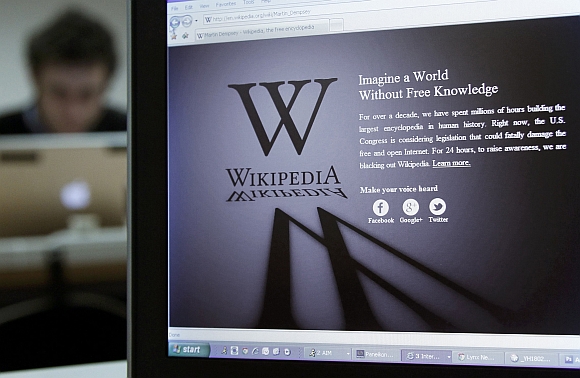 A reporter's laptop shows the Wikipedia blacked out opening page in Brussels