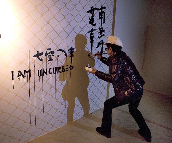 Ono puts up the Remember Us installation at New Delhi's Vadhera Art Gallery. She painted the words 'I am uncursed' in different languages on one wall