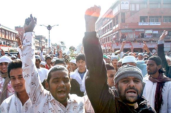 Protestors shout slogans against author Salman Rushdie