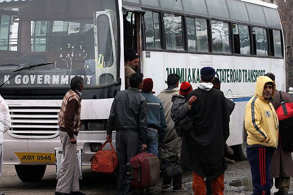 Stranded tourists board a state government bus to the airport, where IAF's aircrafts airlifted them to safer places, on Saturday