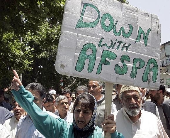 President of People's Democratic Party Mehbooba Mufti carries a placard during a protest in Srinagar