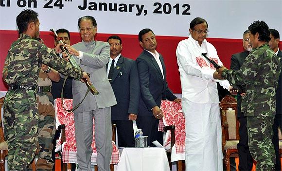 Representatives of Kuki Revolutionary Army outfit hand their arms to Union Home Minister P Chidambaram and  Chief Minister of Assam Tarun Gogoi at the arms laying down ceremony in Guwahati.