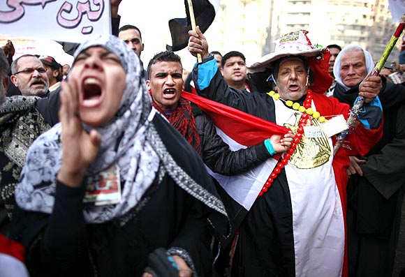 Demonstrators take part in a protest marking the first anniversary of Egypt's uprising at Tahrir square in Cairo