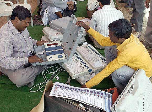 A polling officer checks EVMs in Allahabad