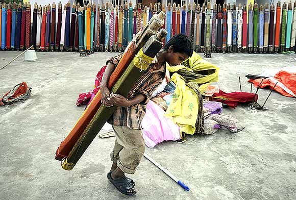 A young boy with rolls of saris in Hyderabad