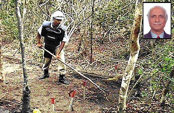 Deminers work in a minefield in Sri Lanka. (inset) Horizon's Chairman Major General S G Pitre