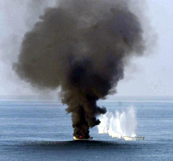 Small boats being towed by a suspected pirate mothership are destroyed February 2, 2011 by weapons fire from the guided-missile destroyer USS Momsen