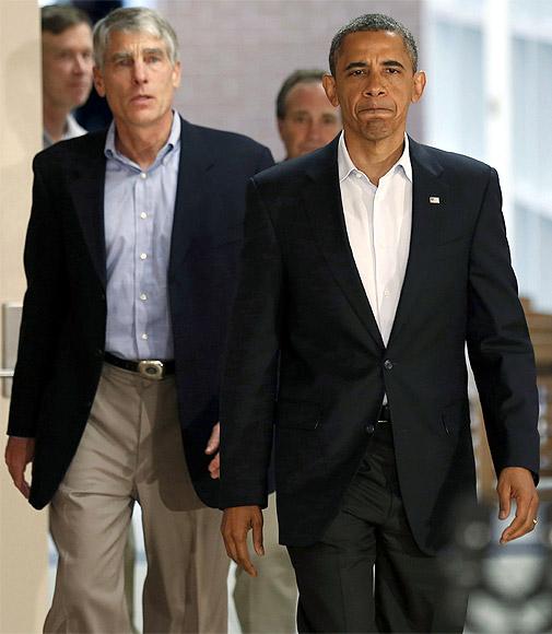 US President Barack Obama walks out with local officials to speak at the University of Colorado Hospital after he met with families bereaved after a gunman went on a shooting rampage at a movie theater in Aurora, Colorado