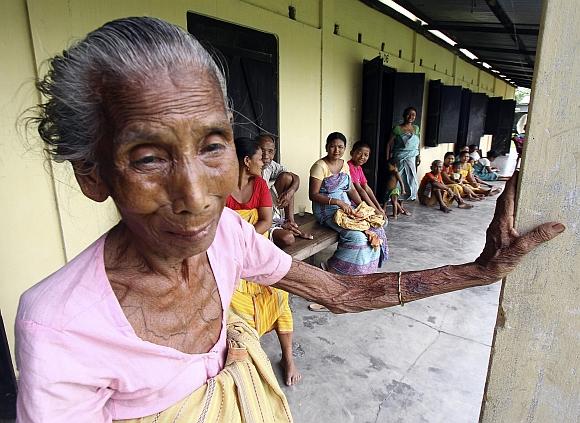 Villagers affected by ethnic riots and their children rest inside a relief camp at Bijni town in Assam