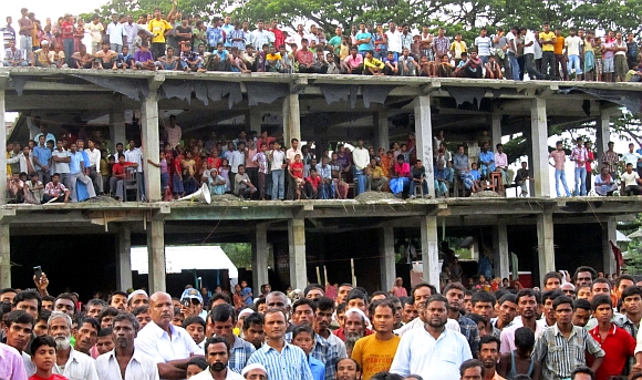 Villagers affected by ethnic riots gather at a relief camp in Bilashipara town