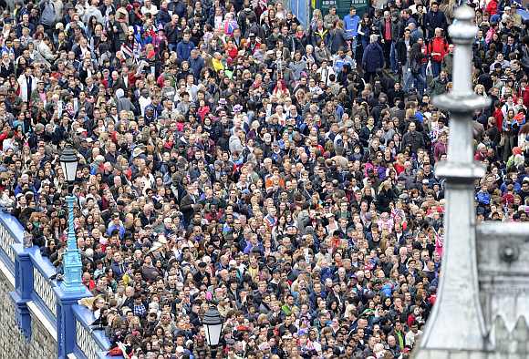 Crowds gather at Tower Bridge on the banks of the River Thames to celebrate Britain's Queen Elizabeth's Diamond Jubilee